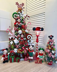 a christmas tree decorated with mickey mouses and candy canes