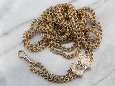 "Dating to the late 1800's or early 1900's, this rare rose gold Victorian chain is detailed with formed, ribbon links. The freely moving black enamel slide is original, and can be located along the chain to create any length 'drop' you feel comfortable with. The finishing beads of rose gold are a bright contrast to the dark patina of the rest of the piece. The craftsmanship is superb, each link forming a tiny work of art. Metal: Yellow Gold Material: Black Enamel Pendant/Slide Measurements: 20 x Victorian Style Formal Jewelry With Chain, Antique Wheat Chain Jewelry Gift, Victorian Link Jewelry With Curb Chain, Victorian Curb Chain Jewelry, Victorian Curb Chain Jewelry Gift, Victorian Curb Chain Jewelry As A Gift, Victorian Jewelry With Curb Chain As A Gift, Antique Wheat Chain Necklace For Formal Occasions, Victorian Wheat Chain Necklace For Formal Occasions