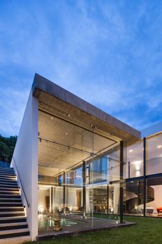 a modern house with glass walls and stairs