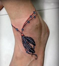 a foot with a feather and beads on it