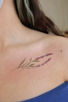 a woman with a tattoo on her shoulder and flowers in the middle of her chest