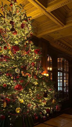 a large christmas tree in the middle of a room