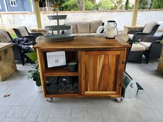 a wooden table sitting on top of a patio