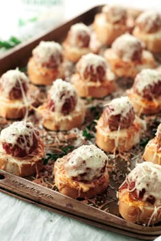 small appetizers with meat and cheese are on a tray