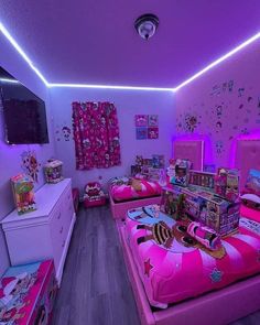 a room with two beds, pink walls and lots of toys on the floor in it