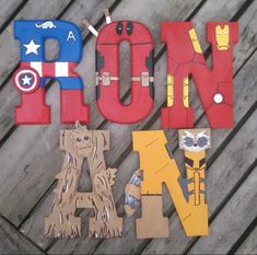 the word iron is made out of cutout paper and wood letters that spell out iron