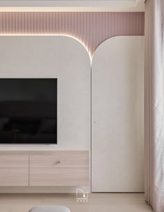 a large flat screen tv mounted to the side of a wall in a living room