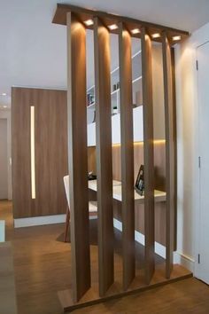 a room divider made out of wood with lights on the top and below it