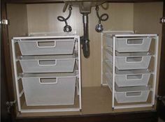 two white storage bins with handles on each side and one has five baskets in it