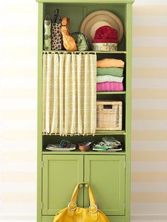 a yellow purse sitting on top of a green cabinet