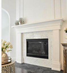 a living room with a fireplace and mirror