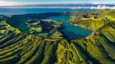 an aerial view of green mountains and lakes