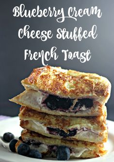 blueberry cream cheese stuffed french toast stacked on top of each other with fresh berries