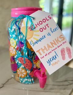 a jar filled with lots of colorful items and a sign that says, schools out summer is here thanks for all you have done this year