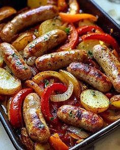 sausages, peppers and potatoes in a baking pan