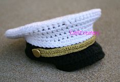 there is a crocheted hat on top of a small black and white object