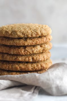 a stack of oatmeal cookies sitting on top of a white cloth