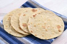 three tortillas sitting on top of a blue and white towel