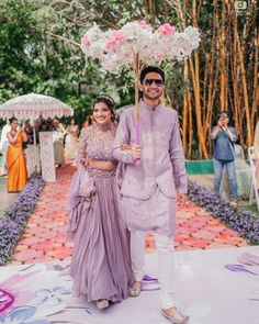 This Couple had a fun-filled Mehendi ceremony with beautiful decor and happy faces. They entered the ceremony hand-in-hand wearing lilac matching colour outfits, looking ravishing and a pretty entry prop made of a floral umbrella. Pc: deepak Vijay photography #indianbride #indianbridalmakeup #mehendi #lehenga #bride #bridesmaid #bridesofwittyvows #indianwedding #decor #decoration #haldi #mehendicremony #weddingdecor Matching Indian Wedding Outfits Couple, Couple Roka Outfit, Haldi Ceremony Outfit Different Colour, Haldi Outfit Ideas For Couple, Groom Mandap Outfit, Groom Lilac Wedding, Mehendi Outfits For Bride And Groom, Haldi Dress Groom, Purple Haldi Outfit