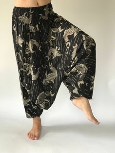 "These super soft rayon baggy unisex harem pants have the \"flow\", perfect of yoga or just a cool strolling. Comfort and character are what these pants are all about. They have the traditional sarong look & feel but a lot more practical when it comes to activity like yoga. As a bonus, they are convertible! Just pull them up and you get yourself a cute jumpsuit in a flash. Together with elastic cuff legs, you can wear them short or long. The pants have smock waist (wide bang elastic) with no Black Baggy Harem Pants For The Beach, Black Relaxed Fit Harem Pants For Beach, Hippie Style Harem Pants For Loungewear, Black Harem Beach Pants, Relaxed Fit Harem Pants For Yoga, Relaxed Fit Harem Pants For Meditation, Relaxed Fit Harem Bottoms For Meditation, Baggy Harem Pants For Meditation, Baggy Wide Leg Harem Pants For Meditation