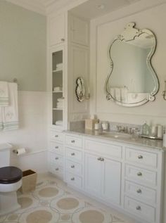 a bathroom with a toilet, sink and large mirror above the bathtub is decorated in white