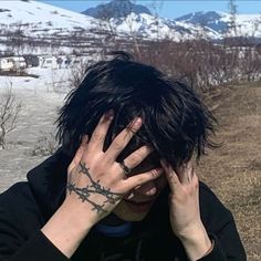 a man with black hair covering his face