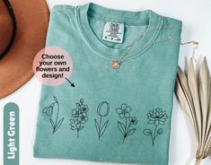 Embrace nature's beauty with our Custom Wild Flowers Shirt, a Comfort Colors botanical tee that makes a perfect gift for any garden lover or friend who adores floral designs. This Wildflower T-Shirt, featuring intricate floral patterns, is an ideal nature-themed gift for her, offering both style and comfort for any flower or plant lover.  Welcome to Gift Vibe Shop - Your Fashion Wonderland! **HOW TO ORDER** Select your color and size, then use the personalization box to choose the design style and the flower(s) you want on your T-shirt. **SIZING** The shirts are unisex and run true to size, but size up for a more oversized fit. Please refer to the photo cards for a detailed size guide. ** SHIPPING**  All shirts are made to order and shipped from one of our trusted US printing partners.  Pl Nature-inspired Cotton T-shirt For Spring, Spring Nature-inspired Tops With Graphic Print, Nature-inspired Graphic Print T-shirt For Spring, Nature-inspired Relaxed Fit Tops For Spring, Spring Nature-inspired Short Sleeve T-shirt, Spring Nature-inspired Cotton T-shirt, Botanical Top With Floral Embroidery And Relaxed Fit, Botanical Floral Embroidery T-shirt For Spring, Botanical Style Floral Embroidery T-shirt For Spring