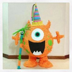 an orange stuffed animal with a party hat on top of it's head and eyes