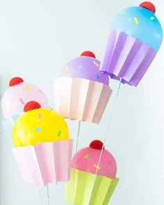 colorful cupcakes with sprinkles and balloons