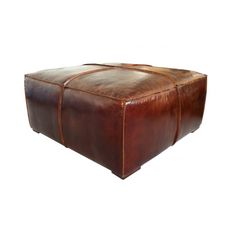 a brown leather ottoman sitting on top of a white floor