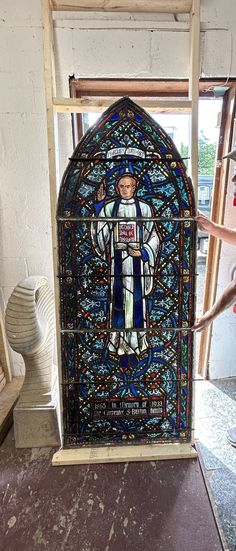 a stained glass window with a person standing on it