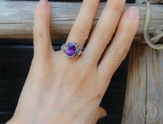 Native American Navajo handmade; this stunning handmade Sterling Silver ring is set with a beautiful oval faceted Amethyst stone with a delicate flower on each side.   Size 4 - I can size up to a 5.5 free.  Measures: 1/2" wide 3 Grams Tested for Sterling Silver This ring can be sized up or down by two sizes for an additional $25 fee. Ring Sizings take approximately 2 weeks turnaround. Add the following listing ID to your cart (253475134610) and send a note with the size you need. Send a message if you have questions. Please use the following link to add to your shopping cart at the time of purchase: https://www.etsy.com/listing/1014930924/ring-sizing-fee-only Thank you for shopping with Highway 66 Treasures! 😊 Please note: Most items are vintage. I clean and polish every item I ship due t Bohemian Oval Jewelry With Accent Stones, Elegant Oval Amethyst Ring With Natural Stones, Oval Amethyst Jewelry With Accent Stones, Handmade Oval Amethyst Spiritual Ring, Handmade Spiritual Oval Amethyst Ring, Handmade Spiritual Amethyst Oval Ring, Handmade Purple Oval Jewelry, Handmade Adjustable Oval Amethyst Ring, Bohemian Oval Amethyst Ring For Anniversary