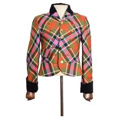 Superb Vivienne Westwood 'Bruce of Kinnaird' Tartan mens jacket from the AW 1988/ 89 'Time Machine' Collection. MADE IN ENGLAND. Features: Velvet Collar, Long sleeves, Satin lined interior, 18 Individually Embossed Orb Buttons, Single hip pocket detail, Velvet cuffs. Outer - 100% Wool Lining - 100% Acetate Sizing measured in Inches: Chest 36" Nape to Hem: 26'' Pit to Cuff; 19" Recommended Size: We Recommend the Jacket to best fit a Medium. Condition is Very Good Despite various pin holes, chiefl Retro Military Outerwear For Fall, Vivienne Westwood Jacket, Mens Runway, Velvet Collar, Pin Hole, Time Machine, Pocket Detail, Vivienne Westwood, Tartan