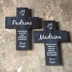 three wooden crosses with the names of four different people on them, and one has a dove