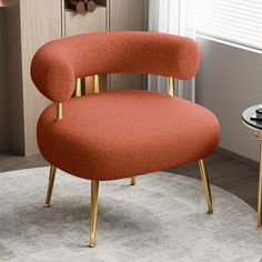 an orange chair sitting on top of a white rug