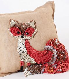 a pillow with a fox design on it and a bag that is sitting next to it