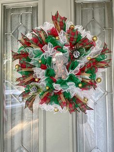 a christmas wreath hanging on the front door