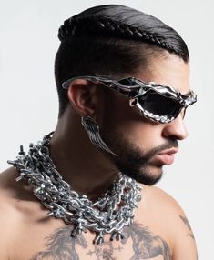 a man with sunglasses and chains around his neck