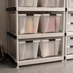 several plastic containers are stacked on top of each other in a storage unit with wheels