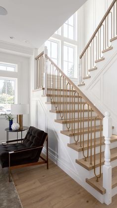 a living room with a chair and some stairs