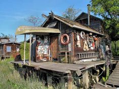 an old wooden house sitting on top of a train track