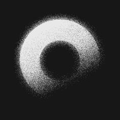 a black and white photo of a circular object in the dark with small dots around it