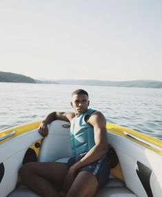 a man sitting on the back of a boat