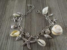 "Amazing and beautiful Natural Shell Anklet bracelet with silver starfish shell charm, Conch shell Ankle bracelet. Seashell jewelry, bohemian jewelry ankle Dancing in the sand anklet is (7 7/8\") with 2.5\" extension 5 Natural Conch shell connected to the bracelet, 9 metal shell charms." Bohemian Silver Charm Bracelet For Beach, Silver Bohemian Charm Bracelet For Beach, Silver Starfish Charm Bracelet For Beach, Silver Charm Bracelet With Starfish For Beach, Silver Charm Bracelet With Lobster Clasp For Beach, Handmade Silver Charm Bracelet For Beach, Silver Charm Bracelet For The Beach, Bracelet Seashell, Anklet Silver