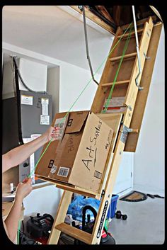 a ladder that has been built into the ceiling with boxes on it and wires attached to it