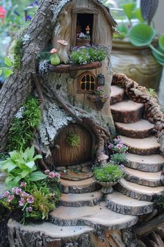 a tree stump house with steps leading up to it and plants growing out of the door