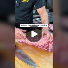 a man cutting up meat on top of a wooden counter next to a butcher knife