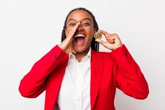 a woman in a red blazer is holding her eye open and making a funny face