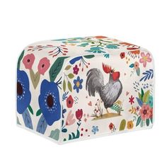 a white and blue flowered box with a rooster on it