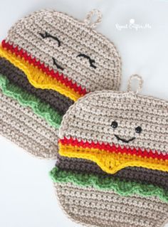 two crocheted hotdogs are sitting next to each other